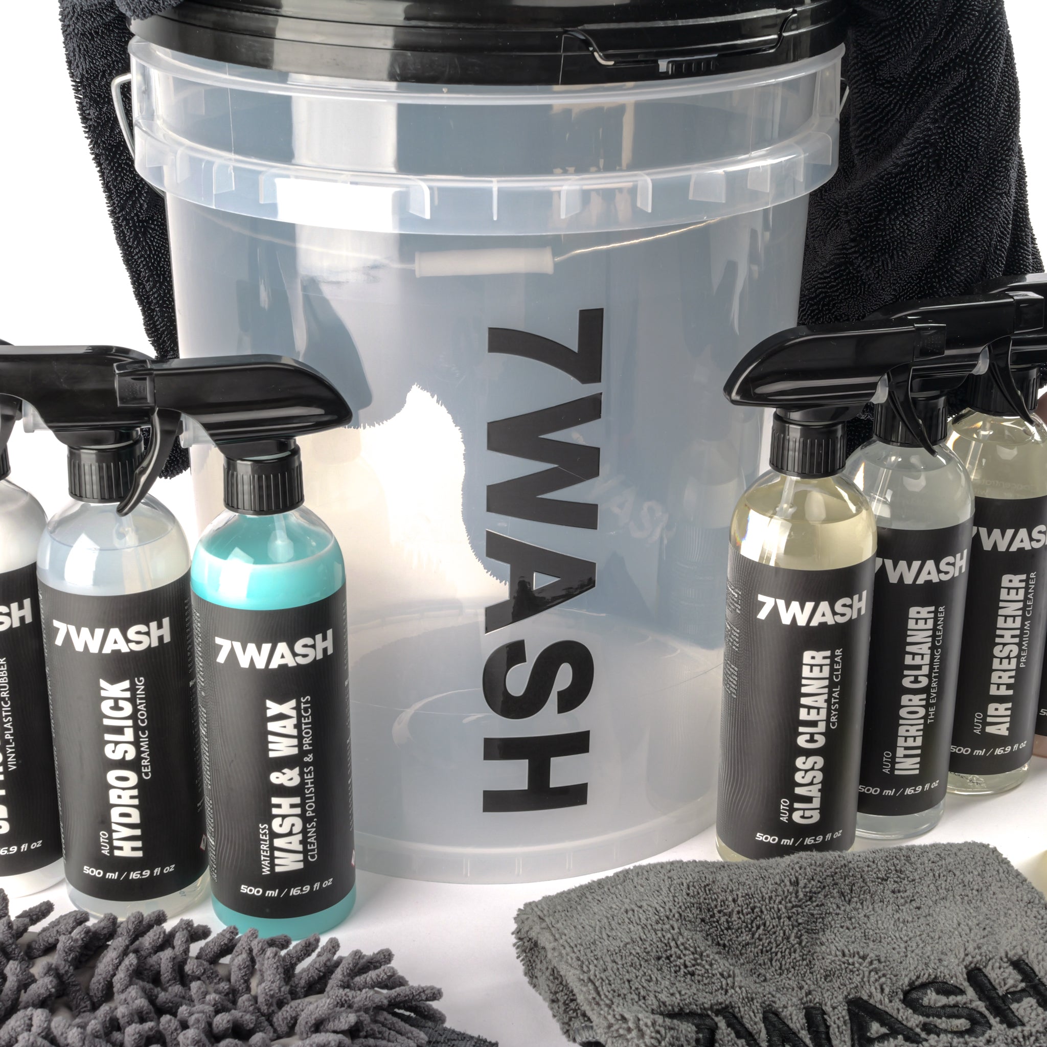 7WASH Exterior Auto-Pflegeset: Transparenter Eimer mit vier 500ml Reinigungsprodukten für Lack, Glas und Reifen sowie Waschzubehör.
